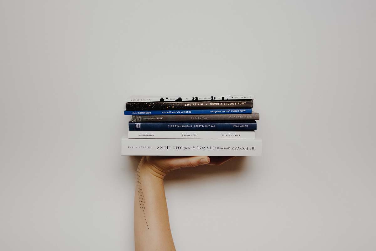 electrical device person holding pile of books connector